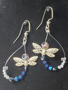 the earrings are made with swarong crystal beads and gold - plated dragonflys