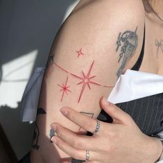 a woman with tattoos on her arm and shoulder