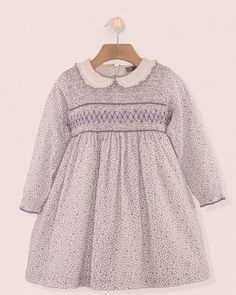 Hand Smocked Perfection. Our Fiorella dress is made in a beautiful French pink floral print fabric and features a fully smocked bodice, long sleeves with elasticated cuffs and a delicate matching ruffle collar. It is fully lined with a fine petticoat. A zip-closure and a matching self tie bow at the back creates a perfect finish. 100% Organic Cotton From France. Fully Lined in Cotton Delicate Machine Wash Cold, Tumble Dry low, Cool Iron, Dry Clean French Pink, Lavender Floral, Hand Smock, Floral Print Fabric, Pink Floral Print, Tie Bow, Smocked Dress, Ruffle Collar