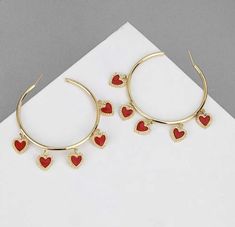 Lightweight gold hoops with hanging red heart embellishments. Perfect earrings for the season of love or a date night with your Hunny. Trendy Single Heart Earring For Valentine's Day, Valentine's Day Party Pierced Hoop Earrings, Valentine's Day Party Hoop Earrings Pierced, Trendy Heart Drop Earrings For Anniversary, Trendy Heart-shaped Drop Earrings For Anniversary, Trendy Open Heart Earrings For Gift, Trendy Anniversary Heart Drop Earrings, Valentine's Day Heart Detail Earrings, Metal Heart Earrings For Valentine's Day