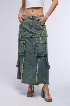 Leave people speechless in The AKIRA Label Say It Again Distressed Maxi Denim Skirt. This bold skirt is crafted from a non-stretch cotton denim fabrication and features functional belt loops with faux silver metallic grommet hardware, raw hem distressed detailing, front mock slant zipper accents, functional front pockets, and dual button-front cargo pockets with strappy embellishments that attach to the back pockets and adorned with faux silver metallic grommet hardware. Complete with a maxi length silhouette, flattering tonal seaming, and a front button zipper closure. Style with platform sandals and a baby tee for a cute, standout look. - Shell: 78% Cotton 22% Polyester - Little to No Stretch - Imported (all measurements are approximate from size small) - 35.5” Waist to Hem - Model is 5’ Maxi Denim Skirt, Denim Maxi Skirt, Long Jeans, Cargo Skirt, Swag Shoes, Baby Tee, Christmas List, Infant Tees, Platform Sandals