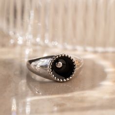 This modern signet ring is sure to get noticed with its bold design and stunning black color. The deep black background and thick ring band is an elegant contrast to the delicately embedded CZ Diamond. It’s both elegant and edgy, making it perfect for any occasion or style. Material: High Quality Solid 925 Sterling Silver Finish: 18K Gold∙Sterling Silver Featuring a ~10mm Black Enamel Signet Ring with an embedded CZ Diamond | Band is ~2.5mm Model showcases a statement, everyday style ring look f Modern Black Enamel Signet Ring For Anniversary, Modern Black Enamel Signet Ring, Black Minimalist Signet Ring For Everyday, Modern Black Enamel Ring For Anniversary, Everyday Black Signet Ring With Polished Finish, Modern Black Promise Ring, Modern Black Round Rings, Modern Black Enamel Open Ring, Modern Black Dome Ring As A Gift