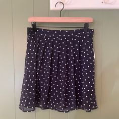 This Skirt Is A Mid-Thigh Or Shorter Skirt With Two Layers Including A Mesh Upper Layer And An Elastic Waist That Lays Flat In The Front And Has The Elastic Stretch In The Back. Color Is Navy With White Polka Dots. This Skirt Has Never Been Worn And Comes From A Smoke Free, Not Pet Free Home Casual Polka Dot Pleated Skirt, Relaxed Fit Polka Dot Skirt, Casual Polka Dot Mini Bottoms, Polka Dot Pleated Skirt For Spring, Relaxed Knee-length Polka Dot Skirt, Summer Polka Dot Mini Bottoms, Polka Dot Skirted Bottoms For Summer, Summer Polka Dot Skirted Bottoms, Polka Dot Mini Length Bottoms For Spring