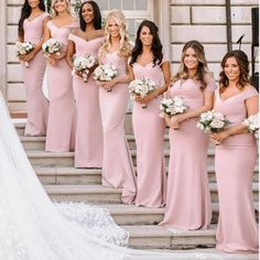 the bridesmaids are all in pink dresses posing for a photo on the steps