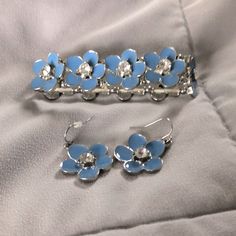 Brand New Blue Flower With Gemstone Accent Earrings & Bracelet Blue Flower-shaped Formal Jewelry, Silver Flower-shaped Metal Jewelry Sets, Elegant Blue Flower Jewelry, Adjustable Light Blue Jewelry For Party, Formal Silver Flower Jewelry Sets, Formal Silver Flower-shaped Jewelry Sets, Blue Flower-shaped Wedding Jewelry, Adjustable Light Blue Formal Jewelry, Light Blue Flower-shaped Jewelry With Matching Earrings