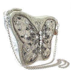 Mary Frances Flitter & Gleam Crossbody Butterfly Handbag Beaded Silver Bag New Flutter away in style with this butterfly-inspired silver beaded crossbody handbag. This trendy bag features glass and smokey grey rhinestones for a whimsical feel and a detachable silver chain shoulder strap so you can unfold your wings and go out in elegance. 11 x 1 x 7" Strap Length End to End: 49" Strap Drop: 23.5" Removable crossbody chain strap, zipper closure, inside pocket, back pocket, fits a cell phone, genu Silver Crossbody Shoulder Bag, Silver Crossbody Evening Bag, Gray Evening Shoulder Bag, Silver Beaded Clutch Shoulder Bag, Silver Beaded Shoulder Bag Clutch, Silver Embellished Bag For Everyday Use, Silver Embellished Shoulder Bag, Glamorous Silver Embellished Shoulder Bag, Gray Evening Clutch Bag