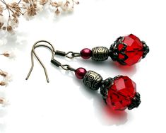 This pretty pair of red earrings will add a touch of vintage charm to any outfit. It is made with red-colored faceted glass beads, small dark red pearly glass beads, bronze-colored metal barrel beads and various bronze-colored metal elements. Metal guaranteed lead and nickel free. Length: 4 cm with clip. 🌹 😉 Don't hesitate to visit my shop "Les Pochons de la Duchesse" to discover my collection of useful and colorful textile accessories: https://www.etsy.com/fr/shop/DuchesseMFC Textile Accessories, Metal Barrel, Colorful Textiles, Glass Bead Earrings, Red Earrings, Faceted Glass, Bead Earrings, Red Glass, Bronze Color