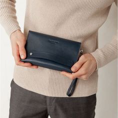 A leather men's clutch is an indispensable item for a modern business man.The accessory is made by hand. Strong genuine leather was used for tailoring.Inside the accessory there are two large compartments and 10 pockets for cards and business cards. There is also a zipper pocket on the front outer wall of the accessory for coins and other small items.The button clutch closes. For convenience, the accessory is equipped with a removable leather loop, which allows you to wear the accessory on the w Modern Wallets With Removable Pouch For Office, Modern Wallets With Removable Pouch, Modern Clutch With Interior Card Slots For Office, Formal Blue Bags With Card Slots, Modern Bifold Bag With Coin Pocket, Bifold Modern Bag With Coin Pocket, Modern Office Clutch With Interior Card Slots, Leather Bifold Clutch For Business, Business Leather Bifold Clutch