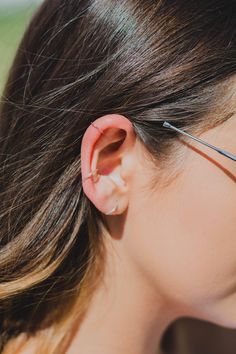 a close up of a person wearing an ear piece with wire attached to the side