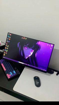 a laptop computer sitting on top of a desk next to a mouse and keyboard,