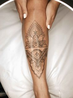 a woman's leg with a tattoo on it