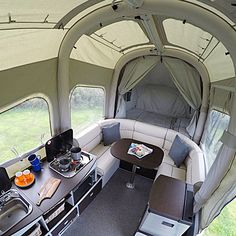 an inside view of a camper with the kitchen and living area in it,