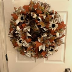 a wreath is hanging on the front door