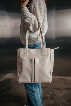 Description: This elegant beige leather tote bag is the perfect blend of style and functionality. Handcrafted from high-quality genuine leather, this bag is designed to be both durable and fashionable. The bag features a spacious main compartment, along with six pockets to keep all your essentials organized. With its sleek design and premium materials, this leather tote is ideal for everyday use, whether you're heading to work, running errands, or going out with friends. Specifications: Height: 30 cm (11.8 inches) Width: 28 cm (11 inches) Depth: 12 cm (4.7 inches) Number of compartments and pockets: 6 Material: Genuine floater leather Hardware: Metal fittings One large main compartment Two additional front pockets One zippered pocket at the back Materials: High-quality genuine floater leat Modern Cream Satchel With Large Capacity, Modern Large Capacity Cream Satchel, Modern Cream Shoulder Bag For Daily Use, Cream Tote Shoulder Bag For Daily Use, Cream Shoulder Tote Bag For Daily Use, Modern Beige Bags For Everyday Use, Modern Cream Shoulder Bag For On-the-go, Modern Cream Satchel For Everyday Use, Modern Cream Satchel For Everyday