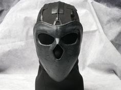 Become the scary Deimos from Rainbow 6 wearing this stunning mask. Hand painted and fitted with tinted lenses. Tactical black balaclava and eco leather straps complete the look.  Make your enemies fear your very presence wearing our top quality face mask! 🎭 Step into the shoes of the enigmatic Deimos from Rainbow 6 with this exquisitely crafted mask! 🌈 Immerse yourself in the tactical world of R6 as you don this stunning Deimos operator mask. 🎨 Meticulously hand-painted and detailed, this rep Black Post-apocalyptic Masks And Prosthetics For Cosplay, Black Post-apocalyptic Mask For Cosplay, Black Post-apocalyptic Style Mask For Cosplay, Post-apocalyptic Full Face Black Mask, Protective Full Face Mask For Cosplay, Full Face Black Mask For Cosplay, Cyberpunk Full Face Protection Mask, Cyberpunk Full Face Mask For Protection, Futuristic Full Face Mask For Streetwear