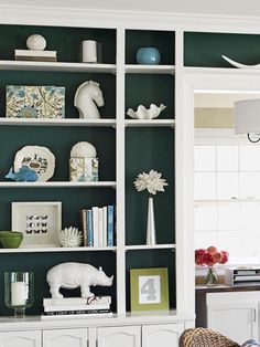 a white bookcase filled with lots of books