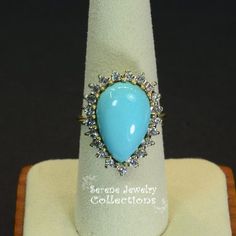 Pretty Levian Sleeping Beauty Turquoise diamond ring, This cabochon is cut in a cute teardrop shape and has a halo of round brilliant diamonds.Ring Size: 7Total Weight: 8.31 gramsPrecious Metal: 14k yellow goldPrecious stones:-Sleeping Beauty Turquoise Center Stone: 17mmx11.5mm, 13.8 carats-White Round Diamonds: 0.63 caratsHallmark: Levian, 14k Gift Diamond Turquoise Cabochon Ring, Elegant Turquoise Teardrop Ring For Anniversary, Elegant Turquoise Teardrop Rings, Teardrop Cabochon Jewelry For Anniversary, Anniversary Teardrop Cabochon Jewelry, Blue Turquoise Teardrop Ring For Anniversary, Blue Teardrop Turquoise Anniversary Ring, Turquoise Teardrop Rings For Anniversary, Turquoise Diamond Ring