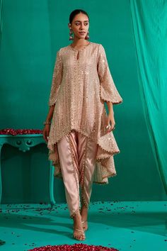 Peach asymmetric, ruffled panel kurta with all over mirror, pearl, thread embroidery. Paired with a tulip pant with pearl danglers. - Aza Fashions Party Salwar Kameez With Mirror Work Traditional Drape, Party Sequin Straight Kurta, Party Georgette Kurta With Gota Work, Festive Sequins Palazzo Set With Straight Kurta, Festive Traditional Drape Salwar Kameez With Sequins, Festive Party Kurta With Sequins, Designer Salwar Kameez With Sequins And Traditional Drape, Party Floor-length Kurta With Gota Work, Bollywood Style Sequined Kurta With Traditional Drape