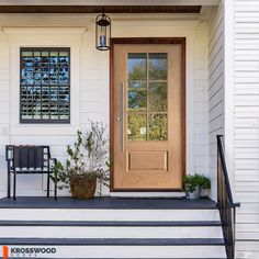 the front door is open and there are two chairs on the steps next to it