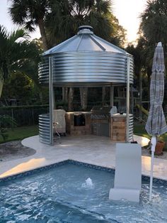 an outdoor pool with a gazebo next to it