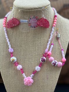 This beautiful pink beaded necklace set is perfect for adding a touch of girly glam to any outfit. The set includes a long necklace with a variety of pink beads, including pink glass beads, pink acrylic beads, and pink seed beads. A sparkling pink star charm and a delicate rose charm add a touch of whimsy to the design. The necklace is finished with a lobster clasp closure. The set also includes a shorter necklace with pink beads and a magnetic clasp closure. Pink Beaded Chain Jewelry For Gift, Adjustable Pink Beaded Jewelry, Handmade Adjustable Pink Necklace, Pink Heart Beads Jewelry For Party, Adjustable Pink Jewelry With Faceted Beads, Cute Pink Heart Beaded Necklaces, Pink Heart Beads Necklace For Party, Pink Beaded Jewelry For Gift, Pink Beaded Jewelry For Jewelry Making