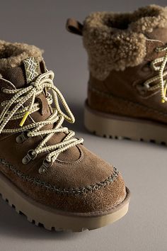 Rooted in UGG® heritage, this boot showcases iconic features like the curly sheepskin collar, UGGplush lining, and smooth suede upper. Round laces and Heritage Twin Seam details give this booth depth, while the lug sole provides traction for those first-snowfall walks. | Classic Alpine Lace-Up Boots by UGG in Brown, Women's, Size: 10, Polyester/Leather/Wool at Anthropologie Ugg Classic, Fall Shoes, Lug Sole, Ugg Shoes, Brown Boots, Ugg Boots, Lace Up Boots, Cute Shoes, Pretty Outfits