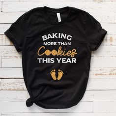 a black t - shirt with the words baking more than cookies this year on it