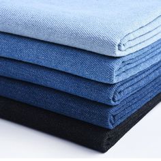 four folded blue and black cloths stacked on top of each other