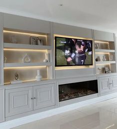 an entertainment center with built - in cabinets and a flat screen tv mounted on the wall