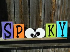 wooden blocks spelling the word spooky with eyes