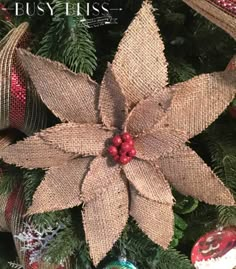 a christmas tree decorated with burlap and red berries