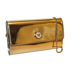 Elevate your evening ensemble with this Versace La Medusa crossbody clutch bag. The reflective gold patent leather complements the iconic La Medusa logo plaque, embedded with white crystals for a luxurious finish. The bag securely fastens with a snap button closure, revealing a chic black fabric interior equipped with 10 card slots and a central zip compartment for effortless organization. Carry it as a sophisticated clutch or utilize the elegant gold chain shoulder strap for versatile styling. Designer Gold Bag With Logo Plaque, Designer Gold Bags With Logo Plaque, Gold Crossbody Bag With Logo Plaque, Gold Evening Bag With Logo Plaque, Luxury Clutch Bag With Logo Plaque, Classic Gold Bags With Logo Plaque, Elegant Rectangular Bag With Logo Plaque, Elegant Clutch With Gold-tone Logo Plaque, Evening Clutch With Logo Plaque