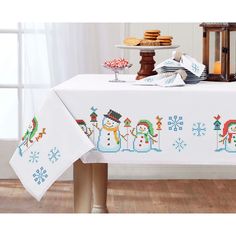 a white table cloth with snowmen on it