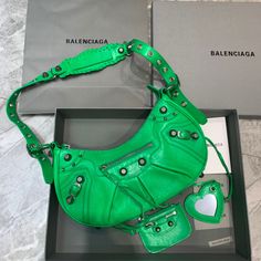 Balenciaga Le Cagole XS Shoulder Bag In Green, For Women, Women’s Bags 13in/33cm Rep 1:1 Size:  33 x 16 x 8.4 cm /13 x 6.3 x 3.3 inches (Lenght x Height x Width) Shoulder bag Adjustable shoulder strap Braided shoulder pad Zipped closure with knotted puller 1 removable zipped pouch 1 removable heart mirror Includes dust bag. This product is of the best quality. Heart Mirror, Balenciaga Bag, Bago, Satchel Bags, Shoulder Pads, Luxury Bags, Designing Women, Contact Us, Fashion Bags