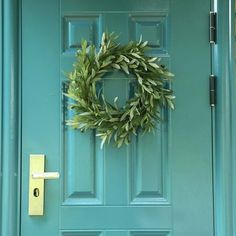 a green door with a wreath on it