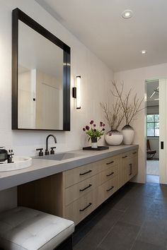 a large bathroom with two sinks and mirrors