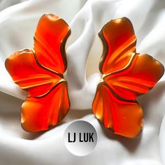 "Make a bold and glamorous statement with our fashion-forward leaf flower design gold with neon orange  glazed enamel  earrings . These stunning earrings are designed to add a touch of elegance and sophistication to any outfit, whether it's for a party, the races, a wedding, or any special function or even to glam up the everyday outfit.  These  statement earrings design exudes glamour and flair, making them the perfect accessory to elevate your look. Whether you're dressing up a simple cocktail Orange Flower Earrings For Gift, Trendy Red Flower Earrings For Summer, Elegant Orange Jewelry For Spring, Elegant Orange Spring Jewelry, Orange Earrings For Spring Gift, Trendy Orange Jewelry For Spring, Spring Gift Orange Earrings, Orange Metal Earrings As A Gift, Orange Metal Earrings As Gift