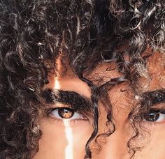 a close up of a person with curly hair