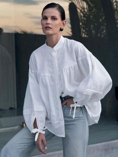 Our Oversized Blouse crafted from pure linen is all about the details. Features elegant gathers throughout, a mandarin collar and billowed sleeve that creates an air of softness. Pair with denim or our Linen Pleat Shorts 100% Linen Natural fabrication A mandarin collar Billowed sleeve with clean cuff and string closure Placket with hidden shell buttons In Natural and Black Color: Natural Material: 100% Linen Care instructions: Machine wash at max. 30ºC/86ºF with short spin cycle. Do not tumble d Oversized Tops For Women, Spring Stand Collar Blouse For Daywear, Stand Collar Blouse For Spring Daywear, Stand Collar Blouse For Daywear In Spring, Spring Linen Top With Stand Collar, Spring Linen Stand Collar Tops, Spring Linen Tops With Blouson Sleeves, Spring Linen Lantern Sleeve Tops, Casual Linen Blouse With Balloon Sleeves