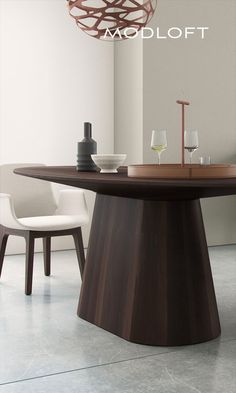 a modern dining table with wine glasses on it