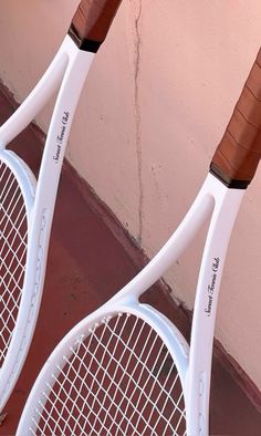 two tennis racquets that are standing next to each other