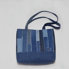 a small blue bag sitting on top of a white table