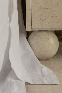 a close up of a white ball under a bed