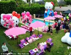 an outdoor party with hello kitty balloons and decorations