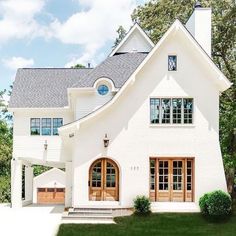 the instagram page shows an image of a white house with wood doors and windows