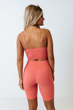 Add a pop of color to your athleisure wardrobe with our cute dusty rose colored 'Up At Dawn' tank featuring lightweight four-way stretch material with subtle vertical ribbed texturing, a scooped neckline, four spaghetti straps, and a flattering figure hugging silhouette that ends in a straight cropped hemline!  on products                                                                    Measurements S-M :  Bust 23", Length 9.5", Waist 21".  L-XL :  Bust 25", Length 10.5", Waist 23". Trendy Sleeveless Activewear With Built-in Bra, Pink Seamless Tank Top For Gym, Summer Activewear With Built-in Bra In Seamless Fabric, High Stretch Seamless Pink Tank Top, Casual Ribbed Scoop Neck Sports Bra, Trendy Pink Seamless Tank Top, Pink Sleeveless Sports Bra With Seamless Construction, Pink High Stretch Crop Top With Built-in Bra, Pink Crop Top With Built-in Bra And High Stretch