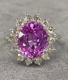 ALL THESE PHOTOS WERE TAKEN WITH AN ORDINARY IPHONE & HAVE NOT BEEN EDITED OR ENHANCED IN ANY WAY. Up for sale is a Stunning Natural Unheated Pink Sapphire & Diamond Halo Ring in solid 18K White Gold. This Ring was made by us Here in New York City & is of the Finest Quality.  The Center Stone is a Beautiful Natural GRS Certified 5.00 Ct Oval Cut Pink Sapphire that measures approx 11 x 9 mm, was mined in Madagascar & Has NOT Been Heated or Treated in Any Way. It has a very attractive Bright Pink Huge Rings, Future Engagement Rings, Diamond Halo Ring, Vs Diamond, Bling Rings, Halo Diamond Ring, Gorgeous Jewelry, Halo Ring, Diamond Halo