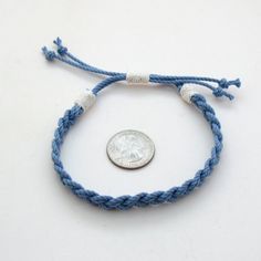 A blue sailor braid woven anklet made to coordinate with our original sailor bracelets. This anklet is fully adjustable and should fit most ankles, opening up to about 13 inches and is a little less than 1/2 inch wide. Made out of braided cotton cord with the ends whipped in a narrower natural cotton cord. This represents three generations of craftsmanship on the coast of Connecticut creating the finest sailor bracelet on the market today. Enjoy what over 50 years of continual refinement can cre Woven Anklet, Sailor Bracelet, Mystic Ct, Cotton Cord, The Coast, American Made, Connecticut, 50 Years, Natural Cotton