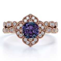 a ring with an oval shaped purple stone surrounded by white and rose gold diamond accents