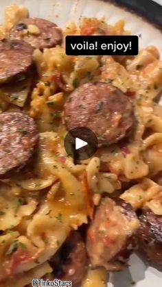 a white plate topped with pasta and sausage